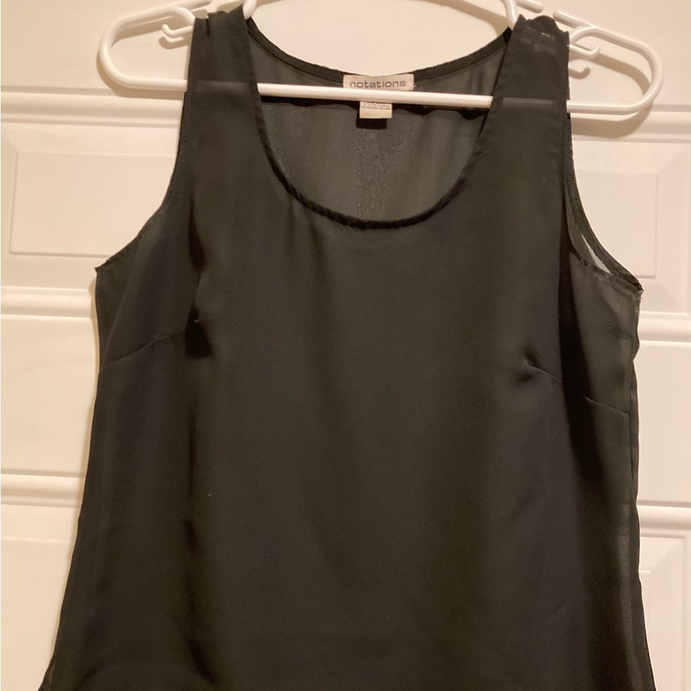 Black, sleeveless, light, blouse…great to wear over swimming tops…